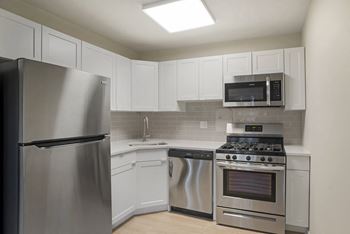 Updated white or grey cabinet finishes in renovated apartment homes